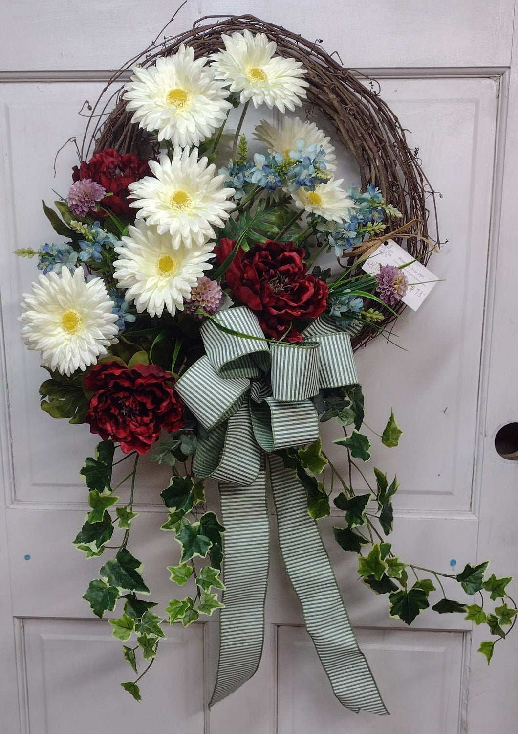 K470 - Wreath with White Gerbera Daisies & Red Geraniums